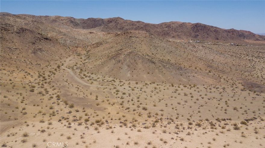 Located just a few miles off Highway 62, this 10-acre parcel in 29 Palms offers a perfect blend of seclusion and accessibility. The land is characterized by its open, expansive terrain, typical of the high desert landscape. The parcel enjoys stunning panoramic views of the surrounding mountains and desert plains, providing a serene and picturesque setting. The area is known for its clear skies, making it ideal for stargazing. Despite its tranquility, the property remains conveniently close to the amenities of 29 Palms, including shops, restaurants, and services. Additionally, it offers easy access to Joshua Tree National Park, a renowned destination for hiking, rock climbing, and nature exploration. This parcel presents a unique opportunity for those looking to build a private retreat, vacation home, or simply invest in the growing appeal of the 29 Palms area.