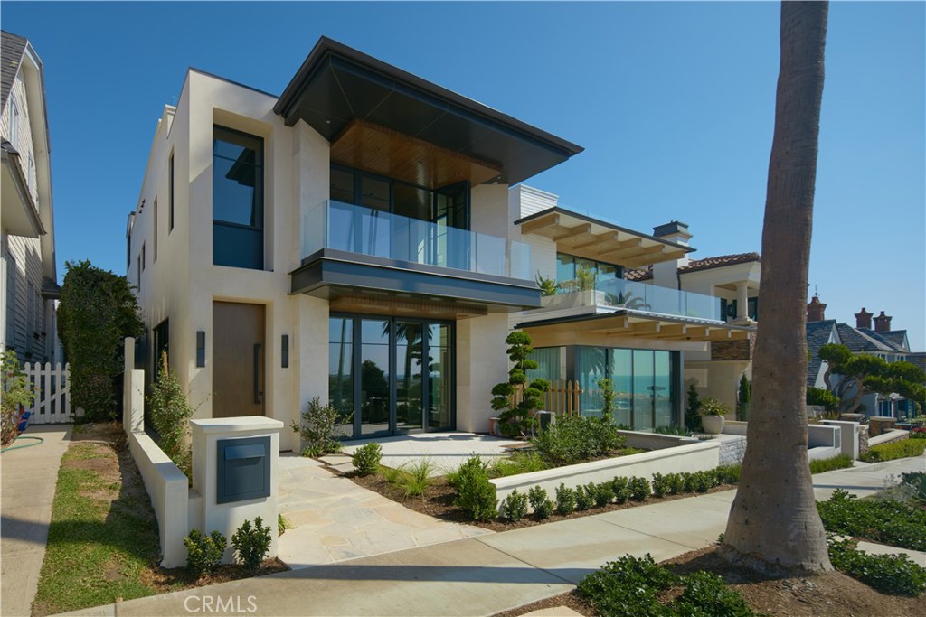 A showpiece in unprecedented luxury and quality, this brand-new (2022) contemporary masterpiece nestled in the coveted 200-block of the Flower Streets reflects the beauty of its setting. Displaying the talents of renowned Brandon Architects, Patterson Custom Homes, and Sage Design Studio, bespoke interiors of appx. 4,592 SF are highlighted by ocean, harbor, main-channel, sunset, and evening-light views. Cleverly configured over three levels, the versatile three-bedroom seven-and-one-half bathroom residence incorporates only the finest materials and finishes such as Warren Christopher white oak flooring, Pacifica stone countertops, tongue-and-groove wood ceilings, and leathered stone fireplace surrounds. Enter past an ocean-view patio and onto the expansive living areas where glass accordion and pocket doors ease the transition between indoors and out. An oversized waterfall-edge island anchors a professional-grade kitchen featuring custom walnut cabinetry, honed slab countertops, top-of-the-line Thermador and Miele appliances, and walk-in pantry. Adjacent is a private courtyard with a built-in BBQ and Neolith stone countertop for cooking al fresco. Completing the main level is a powder bath, three-car garage for the automobile aficionado, and an ideal work-from-home office space with potential for a fourth en suite bedroom reconfiguration. Occupying a separate wing of the second level, a resort-worthy owner’s suite has all the bells and whistles one could envision with dual baths, custom polished dolomite countertops, polished vein cut travertine flooring, two dressing rooms, linear fireplace with floating stone hearth, and an ocean-view balcony. Further along are two en suite bedrooms with a shared balcony and a fully-equipped laundry room behind a stylish barn door. Leaving nothing to be desired, the one-of-a-kind home is arrayed with lifestyle features including an elevator serving all levels, ocean-view rooftop deck offering two patios and central covered cabana, whole-house audio system, Control4 home automation, and expansive subterranean level showcasing a wet bar, wine storage, full bath, and potential for a guest suite. Located in the heart of Corona del Mar, 212 Goldenrod presents an aspirational lifestyle close to a seemingly endless plethora of acclaimed restaurants, boutiques, and resorts.