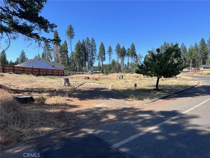 Don't miss out on this one! This lot has so much to offer.....starting with an extra large 11,326 square foot lot with a circular driveway offering unlimited parking and room for all your toys.  Property is located on a bend that turns into a Culdesac with a three minute walk to school for the littles.  The property is located in an area were the electrical lines have been placed underground.  Water was turned on to the property after the fire and was just recently turned off to save funds. There is an existing Cherry tree that has an abundance of cherries yearly even after the fire.  The tree is the only existing tree that lasted through the fire.  The lot boasted of a 2/2, 1536 square foot modular home with a large barn type garage.Unknown septic condition. It was in great working order after the file. Dual leach lines on the property with a switch over. All this lot is waiting for is someone to bring their dreams to life with the land!