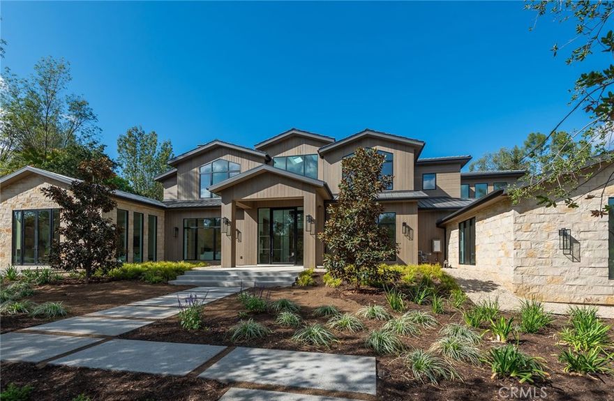 This just completed and truly beautiful, new custom estate is nestled on a lushly landscaped and gorgeous 1.4 acre lot. The superb open floor plan is flooded with natural light and is highlighted by excellent quality finishes throughout. Features include a stellar chef's kitchen, entertainer's center island with counter seating & sunny breakfast room, all opening to the large family room with motorized, sliding walls of glass, two-sided fireplace and adjoining entertainers lounge with cozy seating bar. Additional amenities include a gracious formal dining room with glass encased, refrigerated wine wall, spacious custom office with huge picture windows, a stunning home theater with fabric covered, acoustic sound walls, and gym with full bath and steam shower. There are six generous en suite bedrooms, four upstairs and two on the main floor. The superb primary suite offers a volume ceiling, full wall windows, a large retreat, stone fireplace, deluxe bath with dual showers & big soaking tub, room sized custom closets and dressing area. The nicely private grounds include a big sparkling pool with infinity edge and oversize Baja shelf, a big spa, two large covered patios, a full barbecue center, mature oak trees, and lot's of grass and play areas. This luxurious home exemplifies the essence of the relaxed, indoor/outdoor California lifestyle.