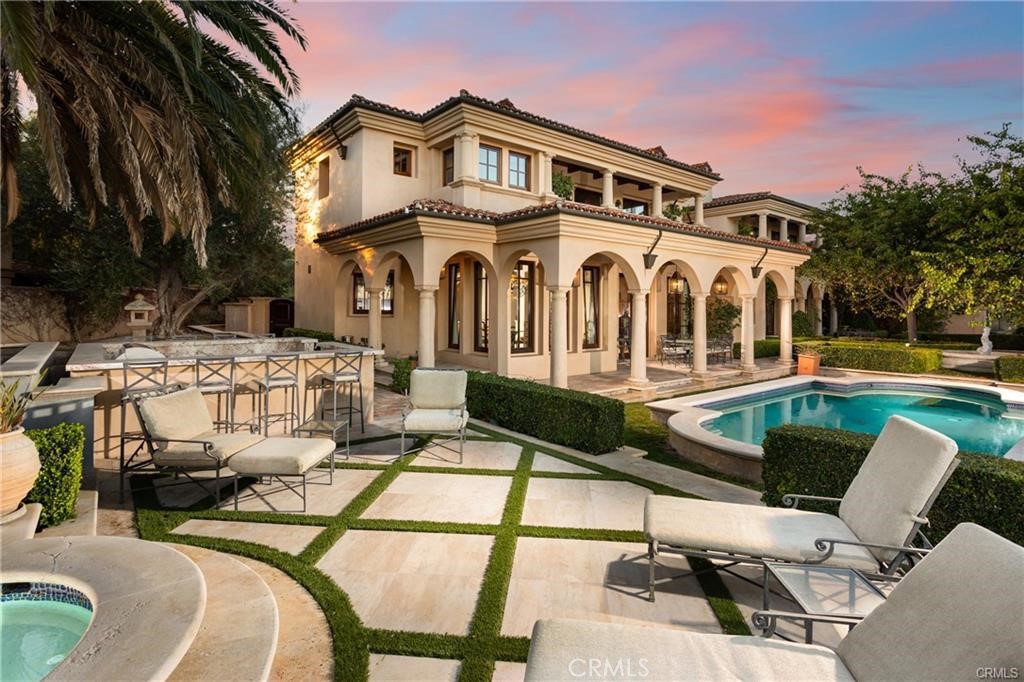 Nestled on a prestigious single-loaded street in the guard-gated enclave of Pelican Crest, this newly renovated custom estate harmonizes Mediterranean-inspired grandeur with modern practicality. A striking dual staircase greets you upon entry, while French limestone floors set a timeless stage. Imported 18th & 19th century fireplace surrounds from France, along with farmhouse roof tiles and walkway tiles sourced from Europe, enhance its classic character.
At the heart of this 5-bedroom home is a freshly remodeled chef’s kitchen, featuring durable natural quartzite with a soft white background and subtle gold veins—combining the elegance of marble with greater resilience than granite. Multiple sets of French doors integrate indoor and outdoor spaces, ideal for embracing coastal California living.
Upstairs, the resort-inspired primary suite pampers with dual walk-in closets, a luxurious soaking tub, and a private balcony showcasing ocean views. Additional en-suite bedrooms—each with its own balcony—offer comfort for family or guests. Entertainment abounds with a private theater, game room, and an executive office suited for remote work.
A subterranean level reveals extensive multi-car garage space, perfect for collectors, plus a secondary laundry area. The backyard has been refreshed to highlight the ever-changing Pacific Ocean. A generous pool and spa, new landscaping, and custom fountain create a tranquil escape, while romantic lighting sets the mood for evenings under the stars.
All just moments from world-class dining, award-winning schools, and the best of Newport Coast, this Pelican Crest estate truly elevates California coastal luxury..
www.7Shoreridge.com