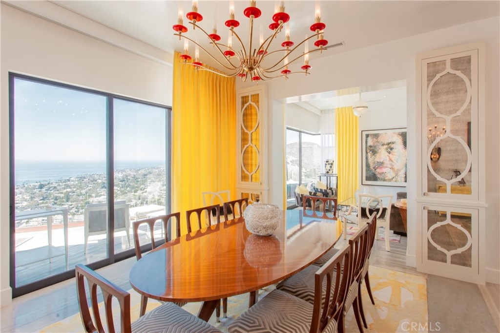 Experience the warm contemporary splendor of this beautiful Laguna Beach masterpiece! Pacific Ocean and Catalina Island views set the mood for every luxe detail in this stunning custom home. Expertly designed by architect Eric Trabert and interiors by Passione Interior Design, this unique home offers three bedrooms, a gym or (or fourth bedroom), office and 3 1/2 bathrooms, a small private pool, and expansive view decks on all levels. An artful gourmet kitchen appeases the eye and the appetite alike with stunning Tiffany Blue cabinetry and premium appliances. Master craftsmanship and the highest quality materials are a consistent theme, delivering both comfort and opulent style. The generously proportioned spaces are richly detailed with an impressive collection including one of a kind vintage lighting throughout. Adorned with exquisite surfaces and stonework, complemented by masterfully executed millwork, no detail has been overlooked to even the most discerning eye. The views out to the endless horizon and year-round sunsets are the living art backdrop to this property and can be enjoyed from virtually any vantage point in the residence. Perched and centrally positioned on a lightly traveled cul-de-sac, this Mystic Hills property is a MUST SEE!