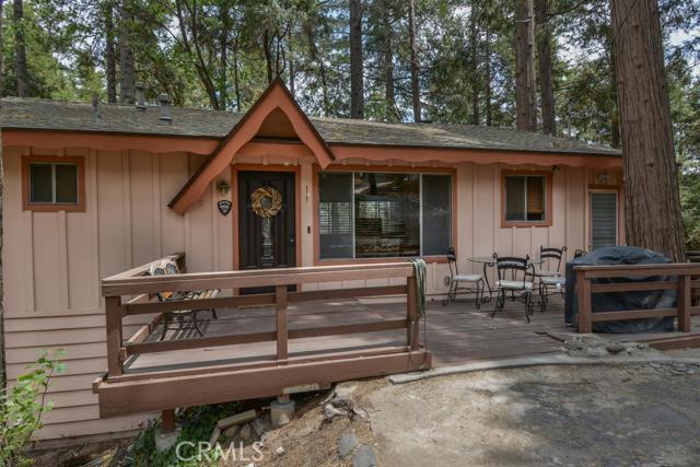 Looking for serenity? Take a look at this beautiful home located at the end of a cul-de-sac and surrounded by fragrant cedar and pine trees! A lovely front deck is perfect for morning coffee or an evening bbq. From the moment you open the front door you'll be taken in by beautiful forest views and a sense of tranquility. The main level great room living area hosts a river rock corner fireplace, and opens onto a deck spanning the back of the house. A generous master suite is also on the main and also opens onto the deck. Downstairs are two bedrooms with another private deck, and a bonus room with a separate kitchenette. The large back yard has storage sheds for your outdoor toys, too. Want turn-key? This home can come furnished per inventory too! It has been a successful vacation rental and the license and bookings can be passed on to new owners if desired. Beautifully maintained, well dressed with stylish upgrades, and close to Lake Gregory - What's not to like? Welcome home!