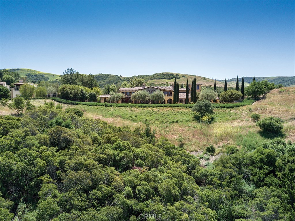 This spectacular estate offers unobstructed views, an approximate 1.5-arce lot, and approximate 15,000 sqft of luxury living. Located in the premier community of Shady Canyon and secured by the privacy of a guard gated entry. The home offers many unique features the impressive gallery entry hall to the multiple outdoor entertaining areas to the incomparable levels of privacy and beauty. The finest materials were used to design and craft the three levels of this expansive estate featuring 7 bdrm suites, 8 baths, 3 power rooms, a subterranean level, theater, wine cellar, indoor pool pavilion and multi-level office suite. Other living areas include a spacious gourmet kitchen and breakfast room opening to the family room and beyond to formal dining and livings rooms. Various unique materials were used to create the design and lifestyle of this spectacular environment including an assortment of marbles, Limestone, Onyx, wood in-lay, custom iron work, egg and dart moldings, coffered ceilings, custom plaster, embossed custom finished doors and more. The amazing grounds have much to offer starting with the size and location to the covered loggias, Limestone terraces, fireplace & grand scale fire pit, large rolling grassy areas, spacious open seating area, reflecting pool & Covered walkways. In addition there are several entertaining pavilions featuring multiple cooking options with all the necessities that go along with entertaining on a large scale or just a cozy dinner for a few.