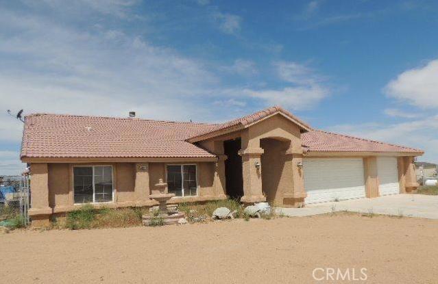 Beautiful single story home In Phelan. Get that great desert living feeling with beautiful mountain views while only being approximately 800 yards from paved Phelan Rd.! Nearly 2 acres for you, your animals, and plenty room to store your toys. Owner pride throughout the home with updated tile and countertops. Entertainers kitchen open towards the living room with a fire place. AC and Evaporative Cooler, Inside Laundry, Bonus Room, 3 Car Garage... and so much more! Association Amenities: None # of RV Spaces: 0 Special Features: SHNONE Frontage Type: Dirt Road Lot Location Type: Standard Location # of Attached Spaces: 3 # of Detached Spaces: 0