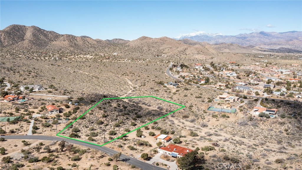 4 ACRE PREMIUM PARCEL located on exclusive Carmelita Circle, tucked up near the National Park. Walking distance into National Park. City water is available in the street, as well as Southern California Edison (SCE) for power. Paved road frontage. No through traffic for privacy. Views of mountains inside the Black Rock Canyon entrance of the National Park. Quiet, peaceful area adjacent to Upper Sky Harbor. Parcel has several building sites, including an excellent location on an elevated knoll toward the rear of the lot, away from the street. The only other two parcels for sale on Carmelita Circle are priced at or near $600k, making this a bargain at half the price of competing lots. Rare LARGE parcel in private location overlooking vast preserved wilderness that will never be developed. Unique opportunity for a discerning buyer. APN: 0589-371-02
