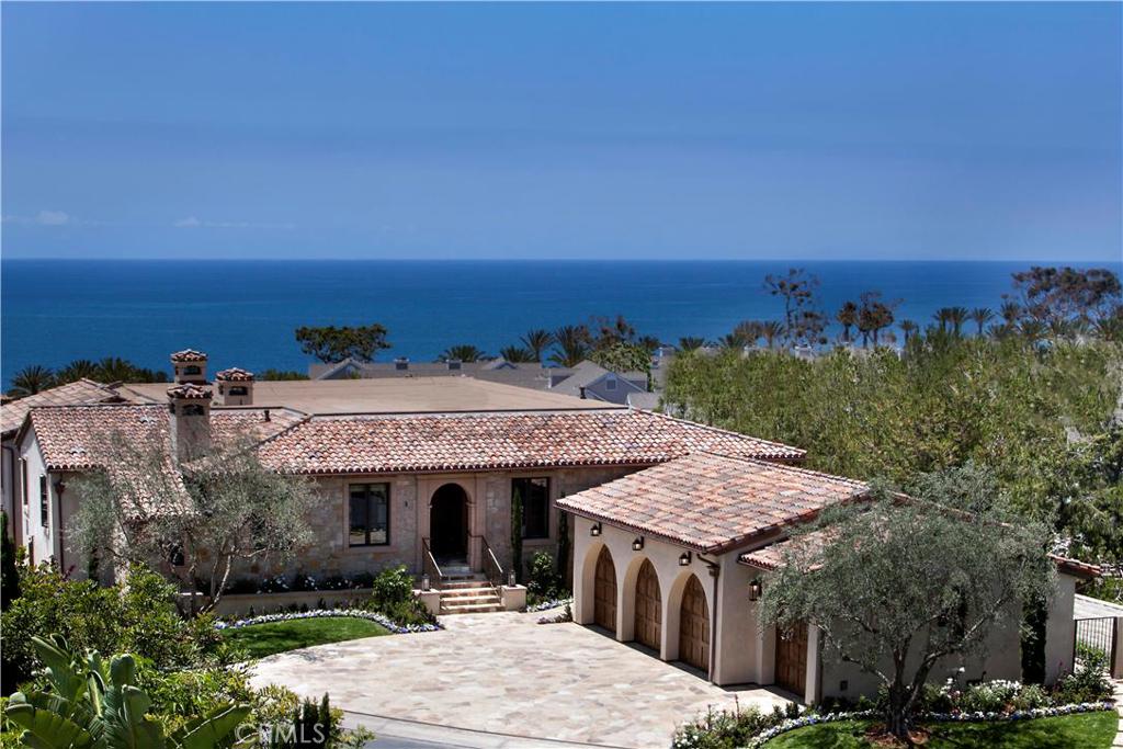 Fabulous panoramic ocean and Catalina sunset views from the expansive great room, kitchen, and casual dining nook area. Please click on Virtual Tour icon. Slide away glass doors open to a seamless transition from indoor to outdoor living between the great room and the beautiful stone terrace. Timeless rural Mediterranean architecture with a modern and light flair for contemporary style and sophistication additionally includes a formal living room and a formal dining room. This home enjoys a huge main level master bedroom suite with panoramic ocean and sunset views. The gourmet kitchen features Neolith Countertops, Wolf and Subzero appliances with Rohl and Kohler Fixtures. Enjoy the best of outdoor living from the large patio overlooking the beautiful stone terrace surrounding the pool, and spacious backyard which features BBQ, pool bar & fire pit. This beautiful custom home offers all this on an extra wide lot, one of the larger lots in The Strand at the end of a cul de sac, and within the beach front community of The Strand at Headlands. One of the many benefits of living at The Strand is the association's 9000 square foot oceanfront Strand Beach Club on three levels, which includes a full gym, steam showers, caterer's kitchen, lounge, pool & spa and BBQ's.