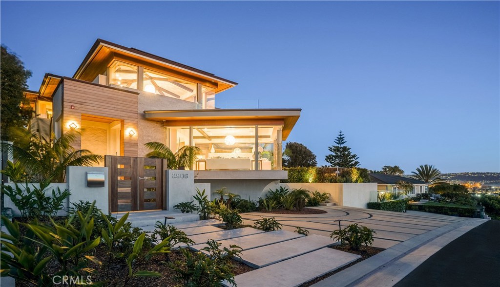 Singularly Spectacular
Patience. You must have it. Because you’ve waited this long. Other properties were high—but not this high. A few had views—but not from P.V. to Malibu and everything in between. Some had great design—but poor craftsmanship. This 5-bed, 8-baths 7,267 s.f. home is proof that patience pays off—handsomely. The flat 14,918 s.f. lot is reportedly the highest west of Sepulveda in all of Manhattan and Hermosa—so the views are outrageous. You don’t have to sacrifice a backyard for those panoramic ocean vistas as with so many hillside homes. This is a hillside knoll, with a huge yard & a pool & a sports court & outdoor entertaining areas that will make selecting a spot to watch to settle for the evening a real challenge. Getting the picture? This property is peerless. It starts with a brilliant living room where a
monolithic limestone fireplace and walls of glass cantilever into the Catalina Island View. The dining room is understated elegance and the nook is a sunny showroom with doors that disappear into the luxurious front yard with infinity edge Jacuzzi & fire pit. A well-equipped kitchen flows into an inviting great room. You may feel your jaw drop when you see the exquisite view from the master bedroom suite w private view deck. Amenities in abundance. The 7- car subterranean garage will excite any car aficionado. It takes a lot to raise the eyebrows of the local real estate elite so don’t wait for the next one. It won’t come along any time soon.