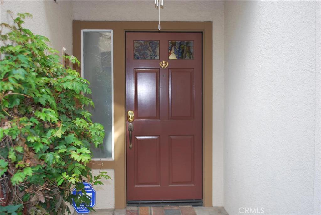 Direct Garage Access to this beautiful ground level unit makes this a rare gem. Enjoy complete peace & serenity in this 2 bedroom 2 bath unit in turn-key condition. Open floor plan offers spacious living room and cozy fireplace which adjoins to a large dining room across from the kitchen. New flooring through out the unit, both bathrooms remodeled and new granite counter tops in the spacious kitchen that offers a lot of counter space with stainless steel appliances. Large sliding door from the living room leads you to the most private & secluded patio which backs to the open space with no neighbors behind you, enjoy a cup of coffee in this lush green outdoor space that is surrounded by greenery. The one door attached garage with direct access to the unit offers space for full size laundry and plenty of storage. Complex offers lots of parking for your guests & visitors. Association offers pool and spa, this complex is well maintained & provides beautiful landscape with serenity; yet it is walking distance to the Trabuco Hills Center & Portola Plaza that offer lots of shopping & restaurants. Membership to Lake Mission Viejo, hiking & walking trails. 241 Toll road is minutes away. This unit offers everything you need in a great location.