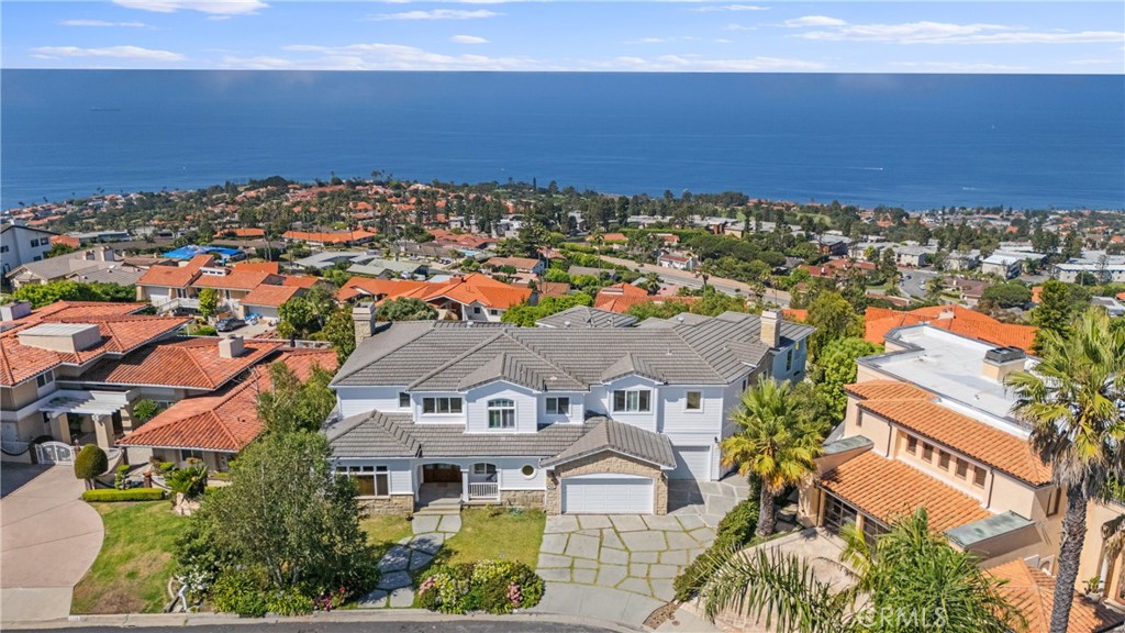 Nestled on top of the Palos Verdes Peninsula, this amazing luxury estate features unobstructed panoramic ocean views from Catalina Island to Malibu. With the 270-degree ocean view wrapping around, you are embraced by the view in almost every part of the home. Find yourself receiving guests
in your formal living room with dramatic high ceiling and two-story windows, or relaxing with your family in the spacious family room, with a built-in wet bar and great view to the backyard and ocean in the backdrop. The large gourmet kitchen will make entertaining a dream with more counter space than you ever need. A butler’s pantry between the kitchen and formal dining room will keep your meals and serving organized with ease. On the first floor there is also a spacious bedroom suite, as well as a classic, wood-paneled private office. Leading up from the elegant wood staircase, you will find the remaining four bedroom suites, three of the bedroom suites all with breathtaking views of the Pacific. The primary bedroom has a truly panoramic view featuring windows and balconies on two sides. Hand-painted details lead to two lavish walk-in closets, the en-suite primary bathroom features rare pink stone counter top with meticulous details. Backyard features view seating and grassy lawn, perfect place to unwind basking in the unobstructed ocean view and California sunshine. Imagine waking up every morning to the sights of ocean and the golf course below, feeling like the King of the Hill, this is truly a one of a kind experience.