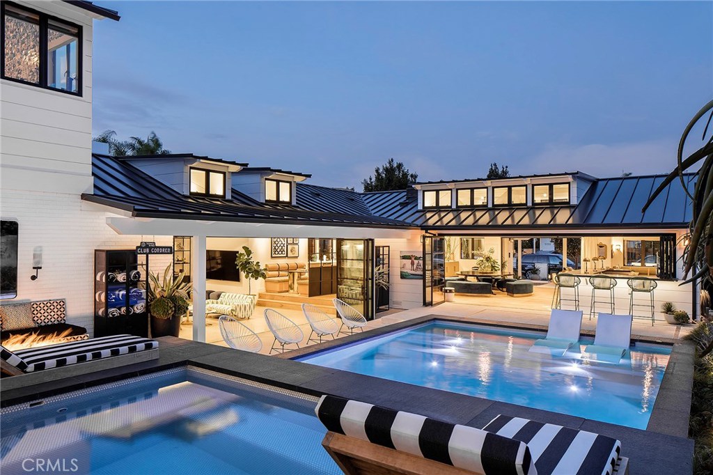 “What happens when you bring together the styles of a restaurateur and a printmaking mogul? In this case…perfection. 2127 Power Street offers an inviting place for neighbors and friends—equal part family sanctuary and party central. Effortlessly combining the exquisitely tasteful with casual comfort to create a place that makes you feel you’ve always belonged there.” – Southbay HOME Magazine
This home is one of the most unique & treasured properties in the South Bay, as it is tucked away in the heart of Hermosa Beach, in a neighborhood historically called Sleepy Hollow & nestled into the hillside on one of the largest lots (21,300+sf) in Hermosa. Offering soothing open space yet easy access to the beach & all of its amenities. Completely remodeled & upgraded in 2017, the house was made to entertain: w/ 2 commercial kitchens indoor & outdoor (w/ an Italian pizza oven), 4 fire pits, a theatre/game room, pool w/ swim jets & jacuzzi, a full circuit gym & lots more! This gorgeous home was intentionally built for entertaining—w/ many beautiful spaces to commune around the property. The layout is open & centered around the penny-tiled pool. The indoor kitchen features plenty of cooking surfaces, multiple ovens, commercial grade dishwasher & hot/cold storage areas. Moving past the great room, kitchen, sunken conversation pit, theatre/game room & a bedroom suite, one finds the opulent, master suite retreat w/ double doors that open to the pool/spa & a gorgeous resort like bath & a closet built for a queen. Up the stairs one finds a communal office/studying open space; forking off that space are 3 bedroom suites each designed to the nines. Just when you think the tour is over, one opens the doors from the office space to a breathtaking backyard. The garden is set up in tiers on the hillside w/ options to play bocce ball or cornhole. The first tier is complete w/ a kitchen, pizza oven & bar adorned in bold, black & white Italian tiles to match the pool. Enjoy fire pits in different hangout areas & a beautiful Zen garden overlooking what looks like could make a nice little coastal vineyard if one wanted. Enjoy the privacy & tranquility of Power Street w/ the white sandy beach & restaurants just a short 4 blocks over the hill. The collaboration of the owners, Jon Starr of Starr Design & Mark Anello of Mark Anello Construction created this truly one-of-a-kind property & once-in-a-lifetime opportunity. Experience beach life, refined to an art form, in a whole new way.