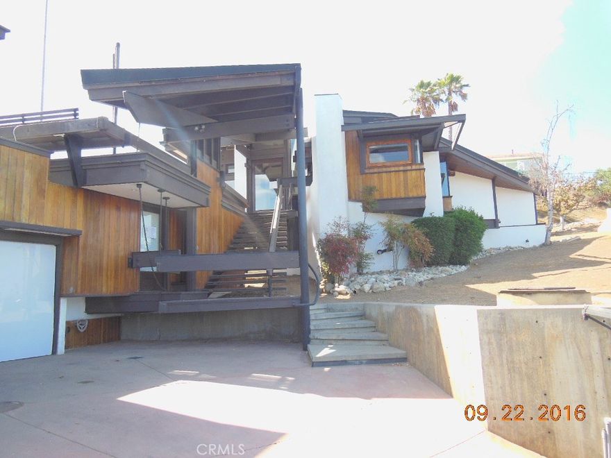 One of a kind custom built contemporary 3bedroom & 4bathroom home with an amazing flair of relaxing city lights, mountain and canyon views. Right on the hills of Hacienda Heights, this location presents a serene and quiet rural setting yet just a few minute drive to the cities bordering Orange County and San Bernardino/Riverside counties; and also convenient drive to downtown LA. House was previously in the process of some renovation works; has 2 unfinished bathrooms; will need some cosmetics repairs to get it to your own imagination of living style.  Master bedroom has its own bathroom and a loft for your extra space like a study room. The other 2 private bedrooms have their own bathrooms and entrances are outside the main structure. This home has bay windows with good views from the inside yet there is plenty of decking outside to hang out with good commanding views. Some windows can be opened for clean cool breeze into the house year round. Huge lot is not all usable as backyard has down slope close to the house. Check this home now and see the great potential it has to offer to your discriminating taste. Property may only qualify for special financing due to repair condition, or all cash. Sold AS-IS, price reflects current condition and location. Have your contractors pre-inspect prior to making an offer.