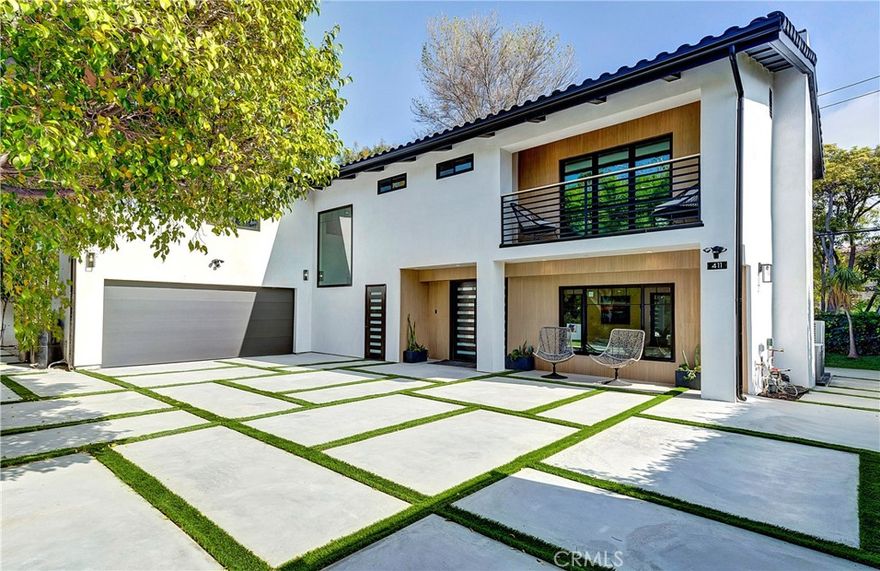 Reconstructed and expanded on a rare flag lot, this residence offers unparalleled tranquility, seclusion, privacy, and security along 26th St, mere steps from the Brentwood Country Mart, North of Montana. Accessed via a private driveway, the gated entryway leads to a motor court capable of accommodating multiple vehicles. The newly configured layout comprises of an open floor plan, 5 bedrooms, 5 bathrooms, and a separate office. State-of-the-art amenities include built-in surround sound, a security system, app-controlled gateway, garage, lighting, and air conditioning. The German-engineered kitchen boasts luxury appliances, leather brush finished stone, unique lighting and a walk-in pantry. Untouched since its reconstruction, this home is designed for seamless indoor-outdoor living, featuring lush surroundings with captivating views of neighboring estates. City of LA services are provided while maintaining a Santa Monica address.