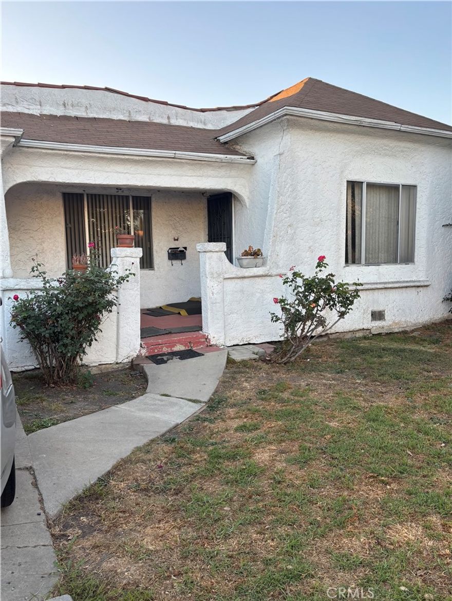 Cute classic home in the thriving area of Mid City! This home features original hardwood flooring and round archways throughout the living room, hallway and dining room with blue carpet in the spacious bedrooms. Dark orange tiles around the gas burning fireplace. The bathroom features a tub shower combination with blue tile and a good sized linen closet. There is an extra space that can be used as an office in between the dining room and kitchen . Private laundry room which leads to the rear of the spacious backyard. Great home for a developer to put their spin on !