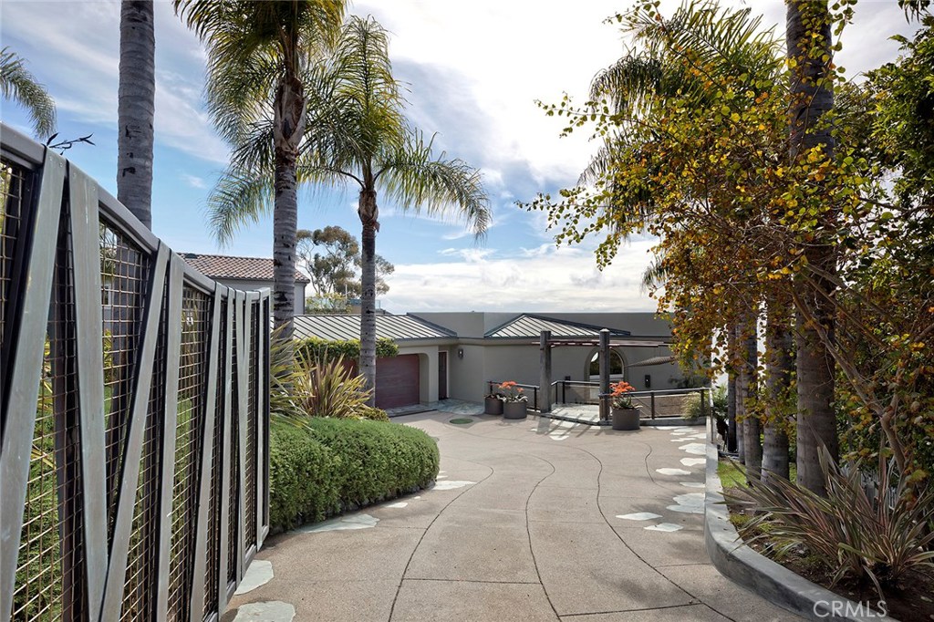 Be welcomed home and drawn into this architectural masterpiece at the renowned, exclusive Table Rock Beach. Enter this one-of-a-kind beachfront property through a palm tree-lined, gated driveway, where you will find parking for up to nine cars for you and your guests. The oversized designer kitchen, featuring the finest finishes, a generous center island, and high-end stainless steel appliances provides a seamless flow into the dining and living areas. Tall windows and private decks provide ample opportunity to appreciate the ocean breeze and views of the ocean, Catalina, the coast, and glorious sunsets over the horizon. Enjoy views from any of the five separate ocean view decks, and take in the serenity of crashing waves while in the tranquil setting of the private backyard’s lush green flora, where just a few more steps take you to your own private beach access gate. This exquisite estate offers the ideal opportunity for beachfront living, without sacrificing any comforts or amenities, giving you the perfect canvas to enjoy the finest of the Laguna Beach lifestyle.