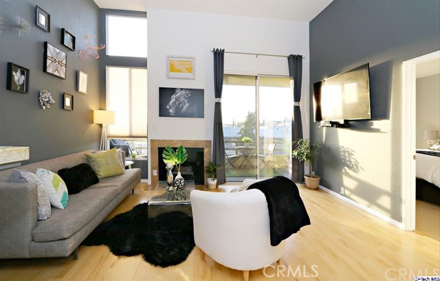 Quintessential Silver Lake! The ease of metropolitan living unfolds before you the moment you enter this light and airy 2 bed 2 bath luxury condo! A bright, open kitchen overlooks the spacious living room with gas fireplace, vaulted ceilings, and access to a private balcony overlooking the city below ~ perfect for sipping morning coffee and dining al fresco! Breathtaking natural light follows you throughout the dining and living areas! The layout is superb, maximizing the space perfectly and offering privacy to both bedroom areas, each with own bathroom access. You will enjoy the convenience of an in unit washer and dryer, underground parking spaces for 2 cars, walk in closets &, charming old hollywood style bathrooms with black and white hex tile! All, situated in a prime location that is right in the heart of all of the vibrant and trendy boutiques, shops and restaurants that Silver Lake and nearby Los Feliz Village have to offer! This is the one!