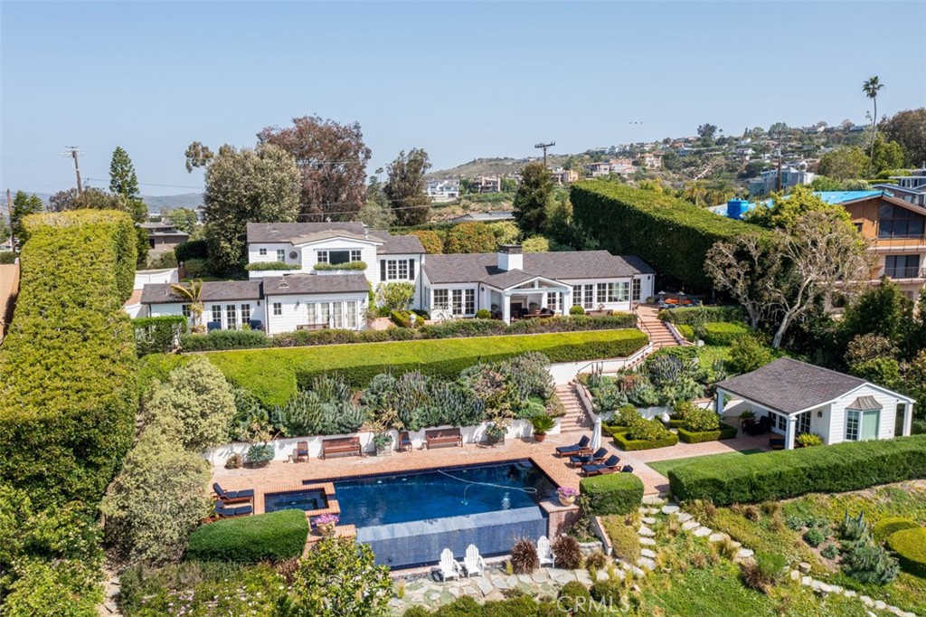 REDUCED IN PRICE BY $1.5 MILLION | ONE OF THE MOST EXQUISITE ESTATE PROPERTIES IN LAGUNA BEACH! 2355 Temple Hills Drive | Laguna Beach. 5 bedrooms, 5 bathrooms plus one-half bathroom, located on almost an acre with far-reaching ocean canyon views. The main residence has 4 bedrooms plus 4 bathrooms, a living room, separate family room, dining room, and a master retreat with a large walk-in closet plus a private outdoor terrace. An outdoor dining area plus separate covered loggia with wood burning fireplace along with a large swimming pool and spa with its own outdoor wood-burning fireplace. Included with this property is a detached guest house with an optional 5th bedroom plus a half bath. Surrounded by lush gardens and landscapes, this rare Laguna Beach estate property offers comfort and privacy with incredible views. There are so many amenities and features with exquisite attention to detail that it is not possible to capture in a brief description. This one-of-a-kind Laguna Beach private estate is a must-see.