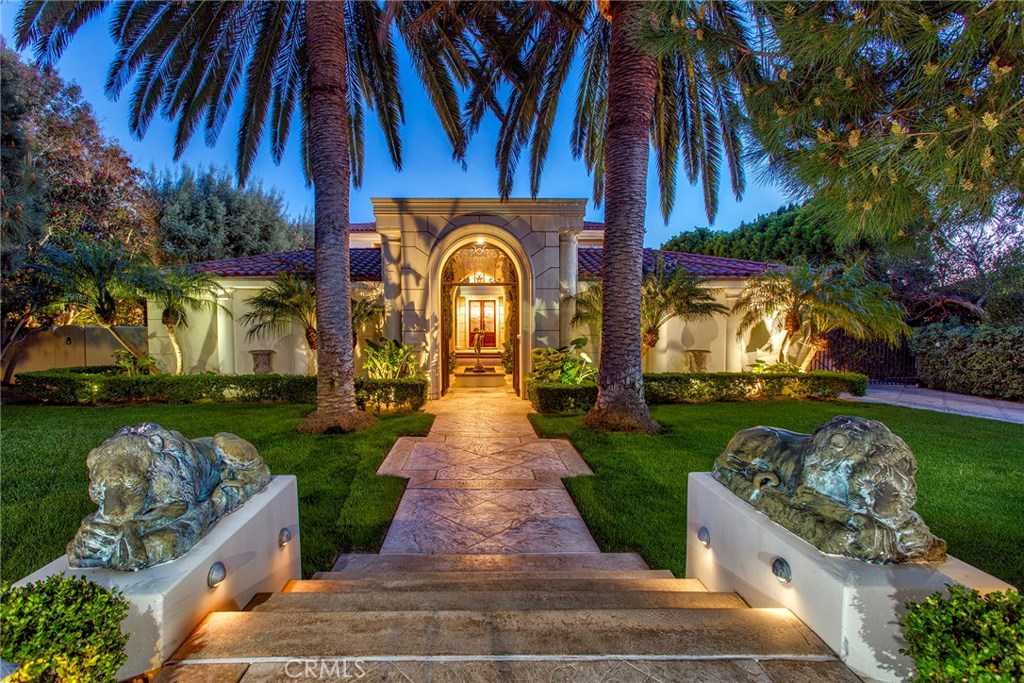 Located in Newport Coast’s private gated Pelican Hill community this palatial estate offers everything one could desire. Positioned at the end of a cul de sac the property offers the upmost privacy and grants a unique amount of space between neighboring properties on either side lending to the tranquil setting. Once through the front gates and courtyard/ motor court you are greeted by the grandeur of the sprawling two story open foyer with wrap around staircase leading you to the formal dining room, living room adorned with cast fireplace, guest bedroom suite and rich wood clad library. At approximately 8,000 sqft the estate offers 4-bedroom suites and 5.5 baths. The main level hosts recently updated gourmet kitchen and butler’s pantry, ocean view media/ lounge space, sunken bar, wine cellar, indoor pool, laundry, powder room and three car garage. The upper level contains the master retreat, two-bedroom suites, and landing overlooking the foyer. Once outside the exquisite hardscapes, outdoor dining, wood burning pizza oven, BBQ area, and lush landscaping lead you to the unparalleled views of the Pacific Ocean, year-round sunsets with Catalina resting in the backdrop.