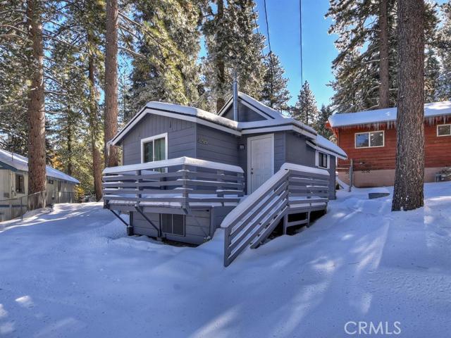 Good things come in small packages! Cozy 1 bed 1 bath ski cabin is located in the heart of Running Springs and is just minutes from the ski slopes. Cabin features a very open floorplan with comfortable living room with gas stove, updated kitchen and bath and bedroom space. You or your guests can stroll to the stores, restaurants. library or post office. Comes with additional 2,793sf lot so plenty of room to add garage or enlarge the cabin.