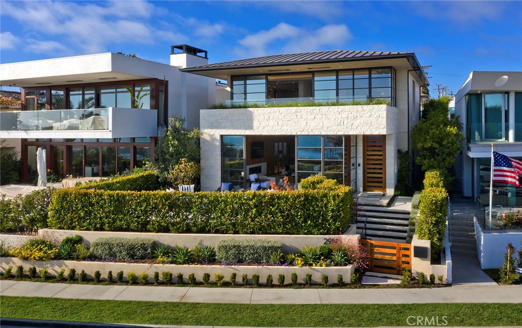 2914 Ocean, expertly crafted for coastal living, offers the best of the California Riviera. Relaxation begins with Lookout Point views—the boating activity of the Newport Harbor entrance, sparkling Catalina Island & sunsets, down coast rocky shoreline, the world famous Wedge surf and Balboa peninsula piers. A stone's throw from Big & Little Corona beaches, Pirate & China Cove, and the casual luxury of the Village's retail & dining, the location and accompanying lifestyle allow you to be as active as you like, or take it all in from the safety & comfort of your living & master bedroom spaces that open completely to the ocean breeze. With contemporary design by brilliant architect Geoff Sumich, 2914 Ocean stuns at every turn. Walls of glass, sleek black metal framed doors & windows, natural stone & wood combine with clean lines into an elegantly livable floor plan on two elevator serviced levels with room for family & guests, and the space and entertainment options for all. Sip a refreshment in the private courtyard spa, shoot billiards by the bar as you watch a favorite movie in the upstairs game room, or unwind with a steam shower. A Control 4 system runs the home so you can keep an eye while away or put the home to sleep from bed. Owner upgrades include full custom closets, garage storage and electronics cabinets and a whole house water softening and filtration system. All that, plus a 5-car garage enjoys the easiest access and best parking in all the village.