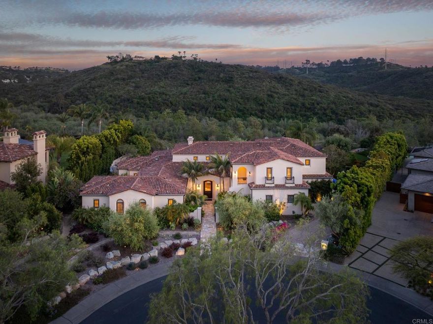 Located in the prestigious and very desirable guard-gated community of Rancho Pacifica on a private and quiet cul de sac on .66 of an acre of beautiful and lush grounds with Southern exposure and canyon views.  Possessing the enviable architecture and style of a two-story Mediterranean-inspired estate, recently updated, with approximately 7,490 sq feet of living space.  The easy flowing floor plan includes a welcoming foyer, formal living room with fireplace and adjacent dining room that lead out to the outdoor great room with fireplace, heater and to the sun-splashed pool and spa.  The well-appointed chef's kitchen with large center island flanked in stone, has all professional appliances, an informal dining bar that opens to the oversized family room with fireplace, beamed ceilings and an area for informal dining.  The sumptuous primary retreat is located at one wing of the residence and encompasses a large bedroom suite with fireplace overlooking the pool, dual custom appointed oversized dressing rooms, spa-like bath with tub, oversized shower, dual vanities and built in storage.  The office/library/music room, adjacent to the primary suite, is flanked in wood with designer details.   There are an additional two suites of bedrooms, all well-appointed on the first level. The second level has 3 large suites of bedrooms, one with a private balcony.  The backyard is an entertainer’s dream where one can enjoy the saltwater pool & spa, outdoor great room with fireplace which is perfect for dining and relaxing and multiple lounging and sitting areas. Other design elements: owned solar, three-car garage with storage, raised gardens, fruit trees, and fully fenced rear yard. A very private a peaceful setting that is also close to all freeways, shopping, new hip restaurants, golf and country clubs, and some of the best beaches in Southern California.
