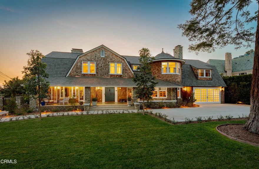 This stunning shingled Hamptons-style residence,originally built in 1895, was recently fully restored and completely renovated from the ground up with no expense spared. Located on one of southwest Pasadena's most historic streets this charming home occupies a prime position in a neighborhood adorned with remarkable architectural properties. The impressive facade is stately but welcoming with a charming large front porch inviting friends to linger on the porch swing. Entering the home,a grand foyer with a graceful staircase immediately introduces architectural elements found throughout the home: beautiful wood moldings and detailed trim work which speak to a bygone era of true quality craftsmanship. The home was recently decorated by sought after design firm Nickey Kehoe,beautifully blending traditional appointments with a savvy color scheme and freshness. The formal living room centers on a beautiful carved limestone fireplace flanked by two sets of double doors which connect it to the family room.The dining room is anchored by an impressive limestone fireplace as its focal point and opposes a stunning mural wallpaper. A large executive office sits at the front of the house in a dramatic room with a curved front wall and, adding a sense of whimsy, a hidden panel in the bookcase leads to a bathroom and additional back staircase. The gourmet kitchen features top of the line appliances and is attached to the breakfast room which features an incredible semi-circular,glass-roofed and sun-filled conservatory.A finished two-car garage equipped with built-in storage,EV charging outlets,and laundry complete the main level. On the second floor, 4 generously proportioned, sunlit bedrooms each enjoy en-suite bathrooms with beautiful, top of the line fixtures and fittings. Additionally, a capacious wood-paneled bonus room offers versatility as a media space or home office with pitched beamed ceilings and cozy window seats,a perfect retreat. Access to the backyard from the family room,dining room and kitchen leads to an elegant patio for alfresco dining and lounging. Meandering paths and stairs lead to the verdant lower levels dotted by old growth trees and a large flat area currently used as a children's play area. With sweeping vistas across the Arroyo Seco this exquisite property is a prime example of true Pasadena luxury, a historic property with stunning light and views in close proximity to the best restaurants and shops of Pasadena.