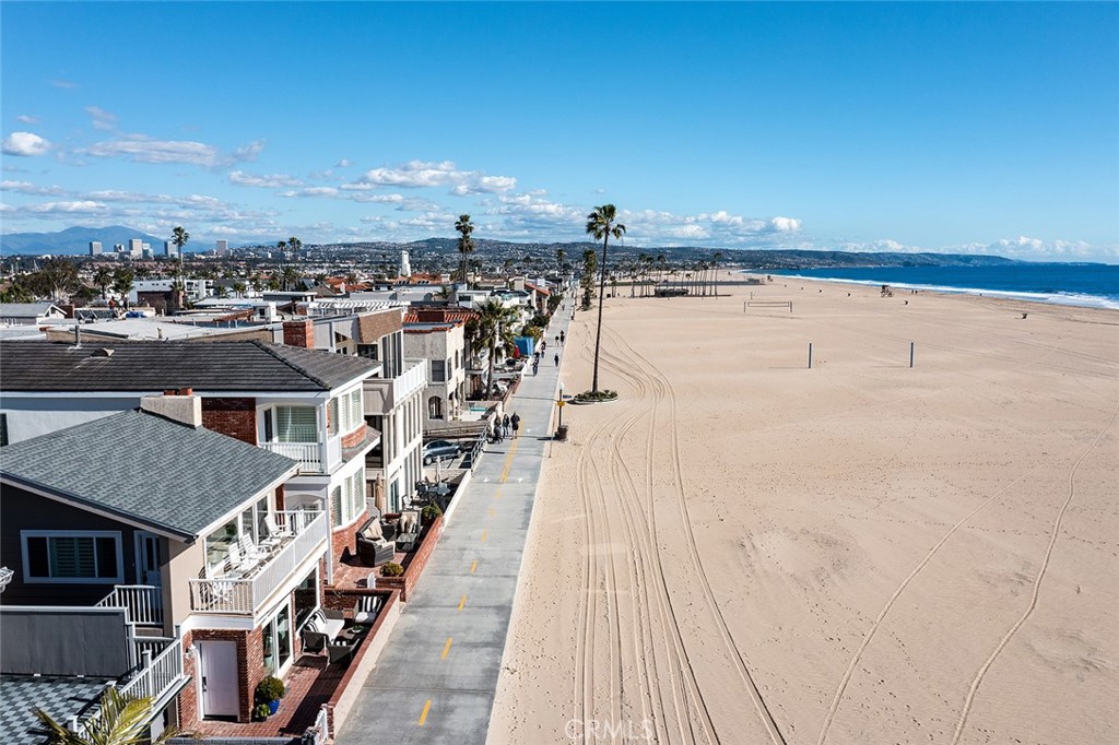 Incredibly rare, highly sought after duplex on the sand in Newport Beach on the peninsula. Panoramic views of the beach, ocean and Catalina from both units. Unbelievable opportunity to live in one and rent the other. A total of 8 bedrooms and 5 baths. The upstairs unit is a large spacious 5 bedroom, 3 bath, while the downstairs has 3 bedrooms, 2 baths. The upstairs includes huge living room with vaulted ceilings, fireplace, attached balcony with impressive views. Gourmet kitchen with granite counters, travertine backsplash, Viking dishwasher & stove, Samsung fridge, breakfast bar & travertine floors. Huge primary bedroom w/ceiling fan, attached bath with designer tiles and heavy frameless shower door. Carpeted bedrooms with mirrored wardrobe doors. Also included, spacious dining area, and laundry room. The downstairs boasts and open floorplan with spacious living room opening to the patio on the boardwalk, ocean views, gas fireplace and attached dining area. Extremely large kitchen with Kitchen Aid fridge & dishwasher and Viking Stove, breakfast bar, granite counters and travertine floors. Primary bedroom with attached bath and separate entrance. Bedrooms include wood veneer flooring & large closets. This magnificent home also includes a NEW roof, dual pane windows, plantation shutters, crown molding, recessed lighting, 2 car attached garage with laundry and automatic opener. Steps from the Newport Pier, restaurants, Marina Park, and Lido Island