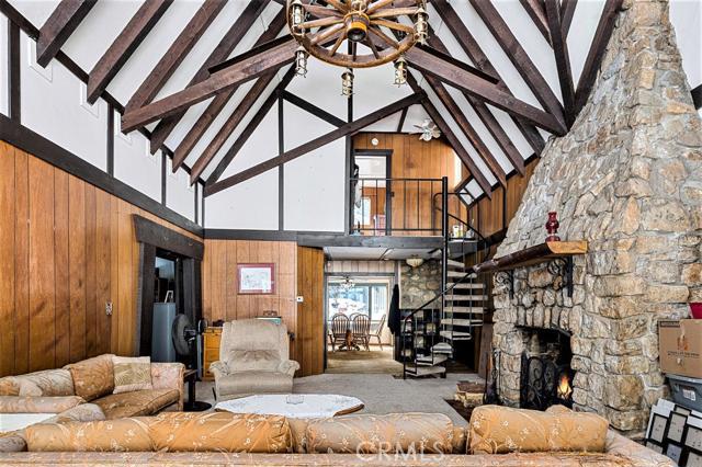 Own of piece of mountain history. Jaw-dropping stone fireplace from a bygone era goes up into the exposed-beam, cathedral ceiling. Beautiful, original, solid-wood doors. Knotty pine ceilings and accents. Picturesque and multi-tiered private back yard with stone walls and vines climbing up the lattice and surrounding trees. Weddings have been performed in the back yard, it is so beautiful! Located on a corner lot with plentiful flat parking. Some work needed, but what a fantastic property! Truly one of a kind.