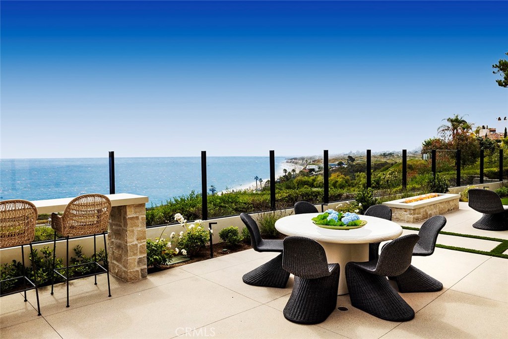 Front row, unobstructed ocean views, white water views, and year-round sunset views, this stunning single family residence has undergone a remarkable and meticulous remodel, transforming it into a sanctuary that radiates both elegance and comfort. Nestled in the prestigious Crystal Cove community, this exquisite property offers the epitome of coastal living. This stunning property is ideally located within a leisurely stroll from the sparkling shoreline, providing you with the ultimate beachside lifestyle. With just a brief 7-minute walk, you can sink your toes into the warm sand or enjoy a refreshing drink at your favorite restaurant in the vibrant Crystal Cove shopping center.
The charming curb appeal features new garage doors and new hardscape and landscaping throughout. The spacious living area offers panoramic ocean views, with such proximity that you can enjoy watching the dolphins frolic from the comfort of your sofa. Two expansive bifold doors open up to the courtyard and backyard offering the perfect indoor/outdoor setting for enjoying ideal Southern California weather. Step outside to the newly landscaped wrap-around backyard complete with firepit, built-in BBQ, and water feature.
The gourmet kitchen is a chef's dream, equipped with Miele appliances, large center island, and an expansive pocket window which offers passthrough access to the backyard. The interior design is sophisticated with high-end finishes and craftsmanship throughout, giving the impression of a newly constructed home.
A main floor bedroom and an office complete the first floor. On the second floor, there are three more bedrooms and a large bonus area. The master suite is a private oasis, offering a serene retreat with its own private balcony overlooking the shimmering waters below and the sound of waves crashing at night. The en-suite bathroom is a masterpiece in itself, featuring marble countertops and luxurious fixtures and hardware.
Located in the prestigious Crystal Cove community, residents have access to a plethora of amenities, including a private clubhouse, swimming facilities, sports courts, playgrounds, and scenic walking trails.