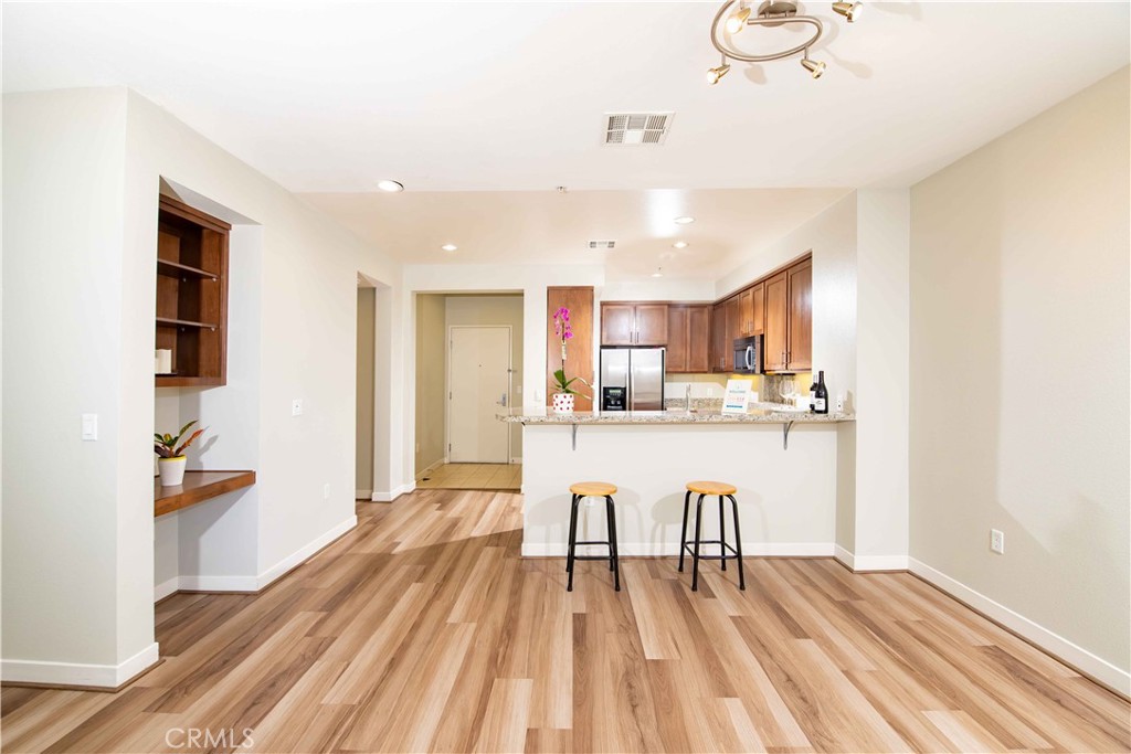 Welcome to your dream modern condo in the heart of Warner Center Woodland Hills. This 2 bedroom , 2 full bath condo offers spacious 1,050 sq/ft living space and built in 2010. The unit includes an updated kitchen with a generous sized breakfast bar with granite counter top, stainless steel appliances, dishwasher, custom Maple cabinetry recesses lights, and AC. The living and dining room leads to a balcony. The en-suite primary bedroom offers a walk-in closet with a double vanity sink & granite counter tops. The second bathroom includes a bathtub/shower. The laundry closet is located in the hallway. There are 2 assigned tandem parking spaces located near the elevator. There is also a locked storage space. The amenities in this gorgeous resort style condo includes a fitness center with many state of the art equipment, pool, spa, cabanas, club house w/kitchen, game room, entertainment lounge w/flat panel television, outside barbecues, fire place, EV chargers, meeting areas, guest parking and dog park. Great location near the Westfield Topanga Mall, the Village and AMC theaters. Close to the 101 freeway. Don't miss this one!