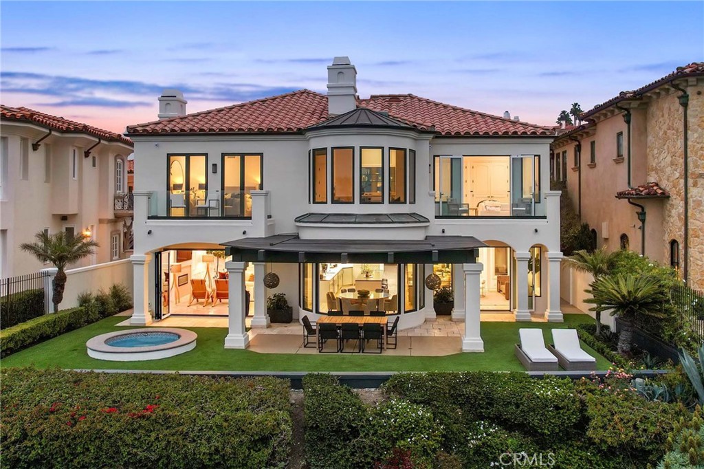 Welcome to this exquisite oceanfront residence situated in the guard-gated community of Ritz Cove, one of the most sought-after coastal communities in Orange County where unrivaled luxury and exclusivity converge. Nestled between the iconic Ritz Carlton luxury hotel and the Monarch Beach Golf Course, this one-of-a-kind beachfront property offers breathtaking year-round views of sunsets over the break at Salt Creek Beach and Catalina Island from nearly every room in the home.
Upon entering, you are enveloped by the welcoming, bright and airy floor plan and feel instantly at peace in your own private oasis. Five bedrooms and five bathrooms are spread across two levels, and a bonus room provides the flexibility to create a home office, media room, or gym. Each room is generously apportioned and flows seamlessly into the next, while bespoke finishes blend architectural elements with contemporary design, resulting in a truly captivating aesthetic. The large curved glass window in the kitchen invites the ocean inside, while the attached living room space creates an entertaining paradise that opens up onto the private patio with spa, setting the perfect stage for outdoor gatherings and sophisticated entertaining.
The master suite is a true sanctuary, featuring an expansive bedroom and private balcony with sweeping views of the Pacific Ocean and the Ritz Carlton, which shimmers in the evening sky. The master bath boasts a lavish soaking tub for two, a separate shower, and exquisite dual vanities, all under a skylight that bathes the room in a glowing light, creating a spa-like ambiance that elevates daily rituals to moments of bliss. The suite extends into an extensive private master closet space apportioned with all the necessary amenities, including a 3-way mirror and attached locking closet.
Additionally, a private stairway with a private gated entrance grants direct access to the pristine beach and countless walking trails directly from the backyard. This breathtaking beachfront property presents an unparalleled opportunity for a personal haven of relaxation and entertaining while offering the most captivating ocean and white-water views.