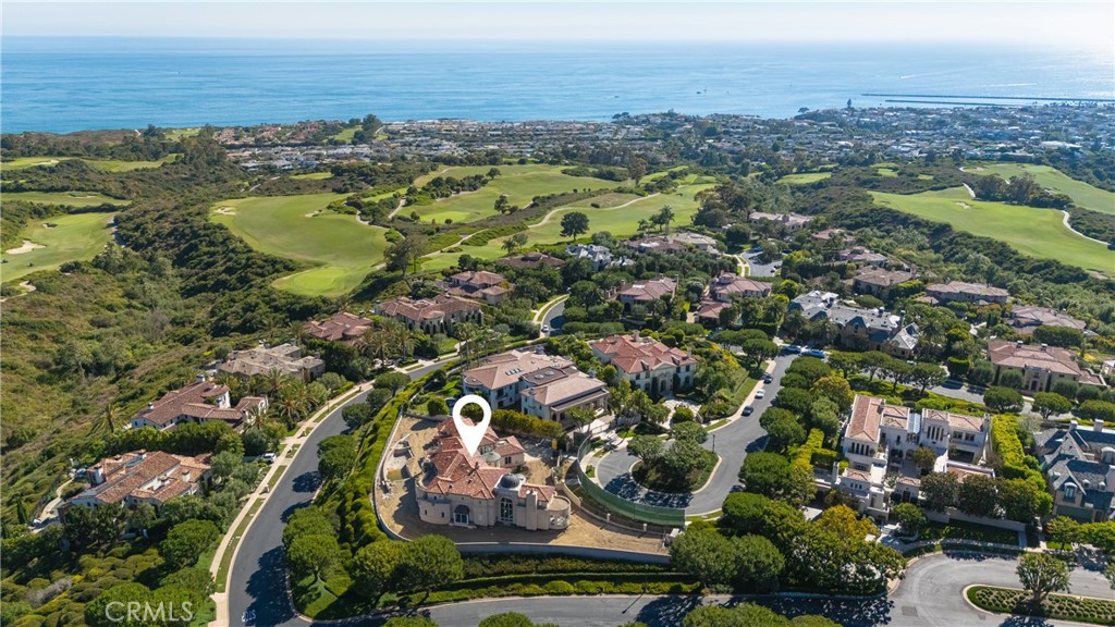 Discover your dream estate within the prestigious, gated enclave of Pelican Hill, where breathtaking ocean and golf course views adorn an elevated homesite spanning approximately 21,000 square feet at the end of a tranquil cul-de-sac. Approved architectural plans by renowned architect James Conrad and exquisite interior design by Morrison Interiors unveil a conceptual vision of an appx. 7,446-square-foot organic modern living space, epitomizing the pinnacle of luxury. This visionary design seamlessly integrates bespoke metal cabinetry, ornate brass finishes, and a magnificent glass-railed staircase. Every proposed detail exudes sophistication, from the elegant stone floors and marble slabs to the decorative tiles and custom mirrors. Designer lighting illuminates the interiors, while rich wood cabinetry and a state-of-the-art refrigerated wine wall add perfect finishing touches to this unparalleled masterpiece. Expansive outdoor areas include wrap-around patios, courtyards, a pool, and a spacious driveway, all set behind private motorized gates. With construction paused, this blank canvas offers a unique opportunity for a discerning buyer to either proceed with the approved plans and interior design concepts, modify them to their preferences, or create their own masterpiece in one of the most coveted communities in Orange County. Located near championship golf courses, Crystal Cove beaches, John Wayne Airport, and five-star shopping and dining, this distinguished estate truly hits all the marks.