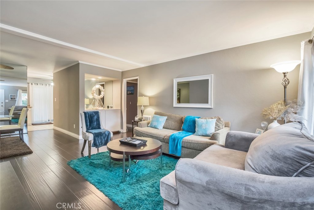 REDUCED! Seller is motivated...Beautiful single level 2 bedroom 2 full bath condo in Laguna Niguel just 2.5 miles from the beach and directly across from the all new Laguna Niguel City Hall and public library. No stairs to climb with your groceries; you enter from the ground level after parking in your convenient carport that has a large lockable storage locker. Very quiet location for this updated home with newer paint and flooring. Wood flooring in the living areas and bedrooms tile surfaces in the kitchen. Elegant bathrooms with newer cabinets and marble like counters. This condo has its own laundry area along with a spacious private back patio for your outdoor enjoyment and relaxation. This complex is one of the best kept secrets in the beach communities. You will feel like you are on vacation year round. This development has a very tropical vibe and your home is idealy located next to the pool and clubhouse. The trash and water bill is paid by the association. This complex will be next to the major new development for the Laguna Niguel Downtown Center complex. This is a fantastic starter home or ideal for someone that is downsizing. Super clean turn key property is waiting for your offer. This complex is not FHA or VA approved.