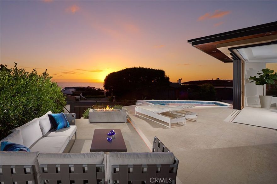 MUST SELL. REVIEWING ALL OFFERS JULY 1, 2019. PRICED BELOW REPLACEMENT VALUE. Occupying a choice corner lot in the coastal community of Crown Point, this sleek new (2018) build delivers both refined style and a premier location just moments to the sand at Crescent Bay, Village eateries and shopping. Gorgeous ocean views are revealed upon entry through walls of disappearing doors that open for seamless indoor-outdoor entertaining and sea breezes. Designed by Mark Teale, the open-concept residence features a modern design aesthetic that is appropriately accented by premium materials and finishes including Portuguese limestone and white oak floors, designer wall coverings, Dornbracht fixtures, and slab trough sinks, to name a few. The upper level of the 4,100+ SF home offers chic dining and living areas adjoined by a statement fireplace; state-of-the-art kitchen with Wolf and Sub-Zero appliances; guest bedroom; and ocean-view master suite with walk-in closet, spa bath, and private balcony. The lower level is equally impressive, boasting a second living area, den with ensuite bath and 2 bedroom suites each with views and access to a private courtyard with waterfall feature.  Equipped with a Crestron system for lighting and shades, Sonos audio (with option to add unlimited applications), elevator, and security system, this one-of-a-kind estate is as smart as it is attractive. A sparkling pool and ‘view-easement’ that ensures forever views, make this estate a cut above the rest.