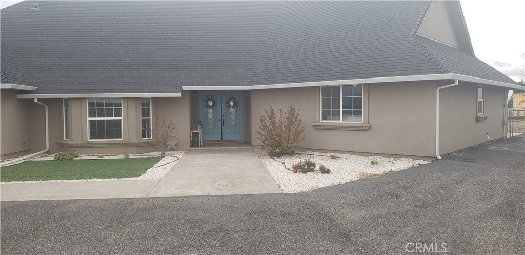 This charming 4-bedroom, 3-bathroom home offers a wealth of amenities for family enjoyment! It features a spacious open kitchen with ample counter space and a large center island that flows into the dining area. The family room boasts a large picture window framing Mount Shasta. The master suite and two additional bedrooms are located at one end of the house, while a sizable bedroom with a full bathroom—ideal for in-laws or guests—occupies the other end. The exterior offers expansive views of the surrounding mountains, including Mt. Shasta and Mt. Lassen, from the 9.77-acre property. The land is sectioned for various livestock, complemented by a covered patio, an outdoor barbeque area, a children's play structure, and a fenced garden. A chicken coop and a covered facility for RV or boat storage add to the property's appeal. Situated just minutes from Downtown Red Bluff, this home is a must-see for those seeking a family retreat. Contact us for a private showing.