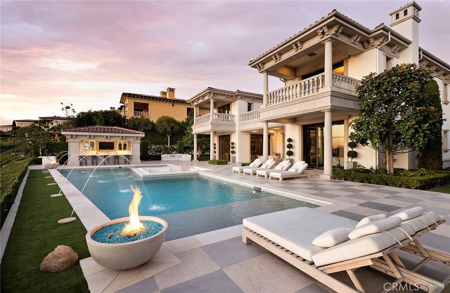 Set behind the exclusive second gates of Crystal Cove on one of the most coveted streets, 18 Coral Ridge melds timeless architectural style with incomparable quality and design.  Spanning 12,628 s.f. +/- with 6 bedrooms and 11 bathrooms, the impressive estate offers a rare 35' height allowance and centers around a dramatic open-air courtyard with a flowing fountain, multiple loggias with disappearing pocket doors, epitomizing indoor/outdoor living.  An expansive great room welcomes your arrival and opens to a jaw-dropping kitchen clad in slabs of marble, luxe Spanish cabinetry, and professional grade appliances and connects to a spacious morning room with fireplace. A secondary caterer’s kitchen connects to the dining room for upscale entertaining, which seamlessly transitions to the interior courtyard and beyond to a separate guest casita. For intimate gatherings, a stunning lounge with onyx countertops and rich millwork offers a private retreat that flows out to the rear grounds.  The upper level offers 4 luxe guest suites and an unparalleled primary suite that encompasses dual closets and bathrooms, a private office and two terraces that showcase breathtaking ocean, harbor, coastline, and sunset views. The lower level houses entertaining spaces that include a bar, seating area/lounge, billiards room, 600-bottle climate-controlled wine room, indoor golf simulator, candy wall, indulgent hidden theater room and access to a 8-car garage with EV outlets and easy access for low-profile vehicles. The sprawling rear grounds feature Portuguese limestone floors oversized pool and spa with perimeter seating and water features, sunken fire pit, poolside cabana with built-in BBQ, bar seating, life size chess board, pool bathroom & a putting green. Crystal Cove is a 24-hour guard-gated community with upscale tennis, swim, fitness, and basketball facilities at the private Canyon Club, with proximity to private parks and hiking trails and convenient walking access to famed beaches, shopping & dining, and the Crystal Cove State Park Historic District.