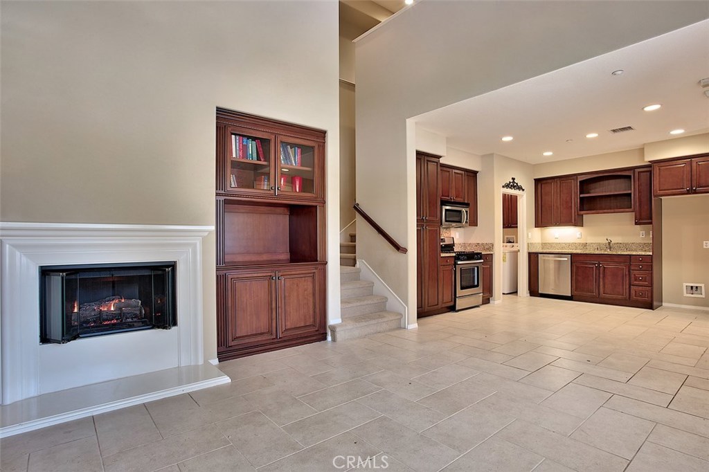 Rare opportunity to lease this one of a kind John Laing builders model in the Celadon neighborhood in Irvine's Woodbury East. Offering an open floor plan of pure luxury, the 3 bedroom, 3 bathroom home has a wonderful layout with a main floor bedroom and a main floor full bathroom, two bedrooms upstairs, each with their own private balcony, plus an upstairs loft space with a built-in desk . Enjoy all the finest upgrades you can imagine including; recessed lighting, fitted shutters throughout, high ceilings and a lovely fireplace in the Great room. The kitchen is equipped with top-of-the-line stainless steel appliances and granite counter tops. There is first class stone flooring which spans throughout the main level. The generously sized Master Bedroom has a large closet with its own private balcony and an incredibly beautiful Master bathroom. The garage has direct access with a separate space that could be utilized for a kids area/motorcycles/storage etc. This gem is located directly across from the private Palm Club community center with its luxurious pool, jacuzzi, fitness center, community room, tot lot and tennis courts. Less than a minute to the Woodbury Shopping Center and Top Rated Irvine Schools. Truly a must see!