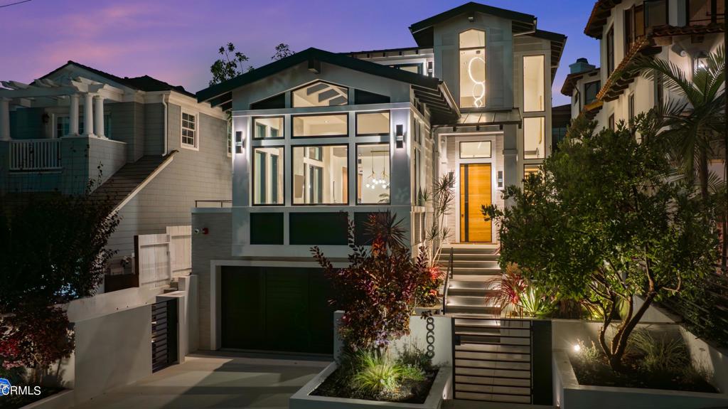 Welcome to your dream home in the hill section of Manhattan Beach. This stunning contemporary masterpiece boasts a perfect blend of cutting-edge design and lavish comfort. With 5 bedrooms, 6 baths, and sprawling across 5,526 square feet, this residence offers the pinnacle of modern living. As you step inside, you are captivated by the grandeur of 24-foot ceilings and an abundance of natural light with an exquisite Flos chandelier. The main level offers a harmonious balance of elegance and practicality, featuring a formal dining room perfect for hosting intimate dinners, an office for those who require a dedicated workspace, and a gourmet kitchen equipped with the finest features to meet your every need. The kitchen is a chef's delight, equipped with top-of-the-line Miele appliances and a sleek design. Fully appointed with custom Snaidero cabinetry, 9-foot floating island, 48 range, a double oven, warming drawer, double dishwasher, wine refrigerator, heated radiant floors, and built-in coffee system combine to create a chef's paradise. Exit outside through two sets of floor-to-ceiling Fleetwood pocket doors to a resort-style backyard that includes a saltwater pool, spa, outdoor shower, firepit, BBQ, and covered heated dining area where you can unwind. As you ascend the staircase to the upper level, prepare to be captivated by a one-of-a-kind hallway configuration adorned with a mesmerizing LED lighting feature. This striking design leads you to 4 en-suite bedrooms that offer unparalleled privacy and comfort. The primary bedroom is a true sanctuary, boasting a cozy fireplace, a balcony with breathtaking Hollywood sign views, and a spa-like bathroom that rivals a high-end resort. The walk-in closet provides ample storage space with custom-imported Italian cabinetry. The spacious lower level has been designed to serve as the ultimate entertainment lounge. It boasts an elegant bar area, complete with double SubZero refrigerators, Fisher & Paykel dishwasher, luxurious finishes and a steam shower. An additional en-suite bedroom in the lower level provides a sanctuary for guests or serves as an ideal area for a personal gym or secondary office. For added convenience, this home features a 3-car garage and an elevator for seamless access to all levels. This modern home redefines luxury living in Manhattan Beach, offering a lifestyle that combines sophistication, convenience and the epitome of coastal living.