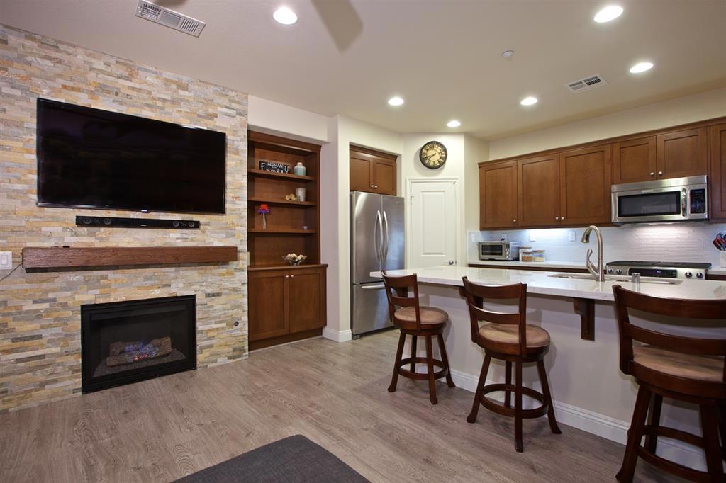 This well appointed three bedroom (w/ a loft or optional 4th bedroom), two and a half bath twinhome features a spacious, open floorplan and upgrades throughout. The entry level is the main living area with the dining room, living room and kitchen, finished with a light gray wood laminate flooring less than one year old. Each space flows into the next promoting togetherness. The kitchen island offers bar seating with ample prep space. Countertops in the kitchen and bathrooms are Lyra Silestone (see supp) Counter tops in the kitchen and bathrooms are Lyra Silestone with a custom glass tile backsplash in the kitchen. The living room features fireplace that turns on at the touch of a light switch on a wall of stacked stone- an upgrade unique to this home in this complex. The built in shelves in the living room were selected to match the kitchen cabinets. Bedrooms are separated by a large loft area on the second floor, a great space for an office, den, playroom or media room. Bathrooms have upgraded flooring and the Master Bathroom has a frameless glass shower. The fully fenced private yard, finished with stamped concrete, has ample space for cookouts and entertaining family and friends. The Laurel complex at Old Creek Ranch, situated peacefully on a San Marcos hillside, offers a safe and friendly feel of a growing community with new restaurants and shops in a walkable village located in the excellent San Marcos Unified schools district. The complex features several convenient amenities including a pool and spa, a barbeque area, playground and a gas fire pit for relaxing on cool winter evenings.. Neighborhoods: Old Creek Ranch Complex Features: ,,,,,, Equipment: Dryer,Garage Door Opener, Range/Oven, Washer Other Fees: 0 Sewer: Sewer Connected Topography: LL