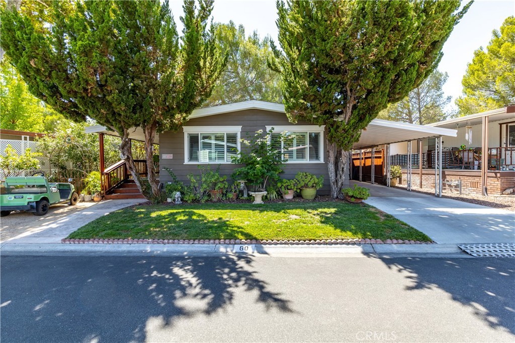 Wait until you see this beauty! Amazing pride of ownership. Finished to an absolute perfection and to please even the most choosy. This home has been updated with a top of the line items. Beautiful open concept kitchen with a custom cut granite, stainless steel appliances and custom lighting. All windows are energy efficient with shutters designed especially for this home. Both bathrooms are updated, clean and bright. Hardwood floors in the main living area are gorgeous and a lush thick carpet in bedrooms is tastefully chosen for the space. Large porch is a perfect place to relax with an exciting book and a drink or pray and meditate. Additional storage is cleverly done in the back of the porch and it easily can serve as a little workshop. This home is located in a 55+ senior manufactured home park. Space rent includes water, trash and sewer and it will not be increased until May of 2026. Home is on HUD so there are no property taxes.