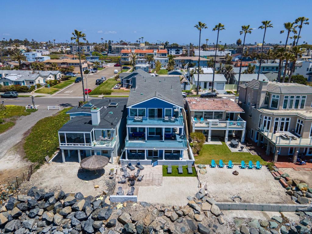 Welcome to 1005 S Pacific Street, a stunning coastal paradise nestled in the heart of picturesque Oceanside. This luxurious beachfront property epitomizes uncompromising elegance and modern luxury. Recently, in 2022, it underwent an extensive renovation that cost over a million dollars, making it one of the city's premier homes. This spacious oceanfront residence boasts an impressive 3,775 square feet, that features 5 generously appointed bedrooms and 5 bathrooms. Every facet of this home has been meticulously curated with exceptional attention to detail, showcasing high-end finishes and cutting-edge design. The property was taken down to the studs, ensuring that everything inside is not only brand new but also of the highest quality. As you step inside, you'll immediately be captivated by the panoramic ocean views that grace nearly every room, flooding the living spaces with natural light and creating an unbreakable connection to the mesmerizing Pacific Ocean. The two chef's kitchens are culinary masterpieces, equipped with top-of-the-line appliances and custom cabinetry, making them perfect spaces for gathering with friends and family to create unforgettable memories. The open-concept living and dining areas effortlessly flow outdoors to an expansive area to work or play, ideal for al fresco dining while taking in the soothing waves. This property is not just a luxurious residence but also a versatile investment opportunity. It has the potential to generate substantial income, with the ability to yield over $470,000 annually as a rental property. It comes fully furnished, ensuring a hassle-free transition for both you and your guests. Start your mornings with the soothing sounds of the waves just steps from your door, setting the tone for a day filled with coastal adventures. After basking in the sun on the sandy beach, retreat to your private balcony to savor breathtaking sunsets over the horizon, painting the sky with a mesmerizing palette of colors. Moreover, there is potential to expand the home by adding an additional living floor without changing the existing roof by finishing the spacious attic. Parking is abundant with a private three car garage and three large driveway spots that can accommodate large SUVs without hanging onto the street—unmatched in Oceanside beachfront real estate. This property also boasts one of the largest beachfront lots in the area. For your convenience, there is also ample exterior storage space for all your beach gear and belongings. The beautifully landscaped backyard offers a serene oasis for relaxation, and the outdoor spaces have been thoughtfully designed to maximize enjoyment and entertainment. In every aspect, this beachfront gem represents the epitome of California beachfront living. Whether you're seeking a primary residence, a vacation retreat, or a lucrative income-generating property, 1005 S Pacific Street promises an unparalleled coastal lifestyle that seamlessly combines sophistication with tranquility. This is an extraordinary opportunity to own a OCEANFRONT slice of paradise along the Pacific coast for less than $1560 a square foot. This also translates to an astounding 12.5 times gross unheard of for an OCEANFRONT property.