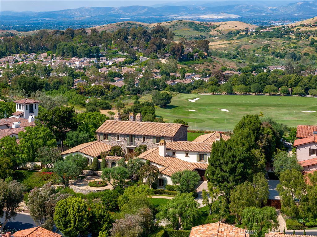 The pearls of the crown in the world-class neighborhood of Shady Canyon, a highly sought-after private community in Orange County. Welcome to 28 Blue Heron, an exquisite estate that offers an authentic blending of Tuscan inspired architecture and spectacular Mediterranean countryside views. Situated on an elevated 0.8 ac square lot, this mansion shares its greeting by a state-of-the-art landscape design with symmetric stone pathways, olive trees and a colorful flowerbed at the center. Following the sandstone paved entrance, a powered private gate opens to an exclusive courtyard with lush green trees, plants, covered patios and a stony framed fireplace. Artisan hand-placed stonework is used throughout the exterior of the home, creating a classical and elegant setting with a timeless vibe. The interior is proudly constructed with the finest craftsmanship and exquisite details, featured with vaulted high ceilings and wood beams, custom made moldings, skim coated plaster walls, red oak hardwood floors, solid core wood doors, designer’s kitchen with pro series appliances, and integrated smart home system that controls lightings, air conditioning, and audio & video equipment through screen touches. The second floor is also designed by symmetric layout, with an ensuite guest bedroom evenly situated on each side, and the centered primary suite that offers a spacious retreat, bathroom with 3 walk-in closets, and a stone-structured balcony with the most breathtaking views overlooking the golf driving range, Mediterranean enriched red-roof villas, and snow-covered mountains at the horizon. Other features include a guest casita, 4 car garage, whole house water softener systems, cargo elevator between the garage and laundry room, a saltwater pool & spa, BBQ Island, and deep grassy backyard. Minutes away from world-renowned shopping centers and miles of sunny beaches, and well secured by two gates, this magnificent estate is your Heaven on Earth.