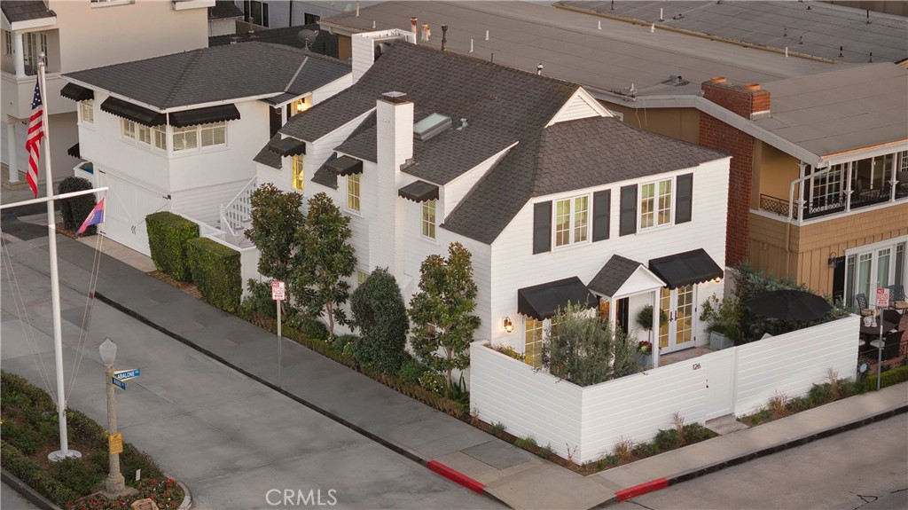 ICONIC BALBOA ISLAND COASTAL MASTERPIECE. Nestled on the Little Island, this historic treasure was built in 1928 by a local sea captain. With nearly a century of memories held within its walls, this stunning residence is a masterpiece of restoration and charm. The home seamlessly blends modern luxuries with a deep commitment to its original character and soul. Situated on a prime corner lot, it enjoys abundant natural light, as well as offering an unmatched sense of privacy.****As you enter the main house, you’ll discover four bedrooms and three-and-one-half baths unfold in a graceful blend of history and refinement. Every inch of this home has been curated with care and meticulous attention to detail, from the lathe and plaster walls to the handpicked finishes, custom-made wainscoting, and exquisite molding. The chef’s kitchen, a true culinary sanctuary, features Wolf appliances, custom cabinetry, and stunning statuary marble countertops, all accented by gorgeous Concept Studio ceramics.**** Designed for effortless gatherings, the spacious dining room flows seamlessly into sunlit living spaces. French doors open to enchanting front and rear private patios perfect for quiet mornings, lively dinner parties, or simply soaking in the sun. For the discerning collector, a temperature-controlled, 600+ bottle wine cellar is discreetly tucked away, providing a secluded retreat for treasured vintages.****Above the garage, the guest house is a private sanctuary with its own separate entrance, offering a gourmet kitchen with Viking appliances and marble countertops, an inviting living and dining space, one bedroom and one bath, and a peek-a-boo harbor view. Whether used for guests or as a highly desirable rental income opportunity, this retreat mirrors the same thoughtful craftsmanship as the main home.****This is more than a residence—it is a rare and treasured piece of Little Balboa Island’s history. With beautiful architectural details throughout, this home is a perfect fusion of timeless craftsmanship and modern sophistication. A true island masterpiece, this residence embodies the elegance, heritage, and timeless beauty of seaside living—a place where the past and present exist in perfect harmony. Subject to cancellation of existing escrow which should be finalized shortly.