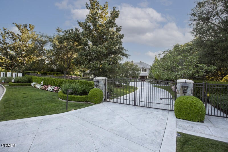 This prestigious home, built in 1996, is a private estate which has been extensively enhanced over the last twenty years with numerous upgraded amenities. Positioned on 1.3 acres of land, this 10,500+ residence is beautifully appointed, yet comfortable and casual for everyday living. The layout of the formal entry, stately living room and dining room are perfect for elegant entertaining of which can flow through the French doors onto the outdoor covered patio. On the first level of the home is a peaceful library with wood built-ins and fireplace, and adjacent home office with dual-sided desks and built-in cabinetry. The kitchen and eating area are open to the large family room boasting vaulted ceilings, a fireplace and media center.Included on the first level is the Master bedroom suite located on the west end of the home, complete with sitting area, a dual facing fireplace, private outdoor patio, two large closets and a well-appointed bathroom. The private guest ensuite is positioned on the east end of the home. The second level offers a media/entertainment room with the option to be used as a home theater, of which can also be an additional home office. Adjoining this room is a unique 'collectibles' room with extensive display cabinetry. The second level also offers four private ensuite bedrooms and a craft/study room. The second level is accessible by three different staircases.The expansive backyard has been completely reimagined with the expertise of a noted local landscape architect. You will find a variety of rose gardens, trees, and mature landscaping that encompasses the yard with beauty and privacy. The patio leads to a large, gated Pebble Tec saltwater pool and spa with a changing bathroom and storage. Below the pool area is a patio and sports court with pickleball and basketball, a garden and a pathway that leads to a tranquil sitting area. The entire backyard is bathed in extensive lighting for a beautiful evening ambiance. The home is positioned back from the street and is enclosed by gates. It boasts a high tech security system, creating a safe environment.La Canada Flintridge is strategically located just a short commute to Downtown L.A., the Burbank-based entertainment companies, the Burbank Airport and FBO's, Glendale, Pasadena and the Rose Bowl. This prestigious community is known for nationally recognized public and private schools.