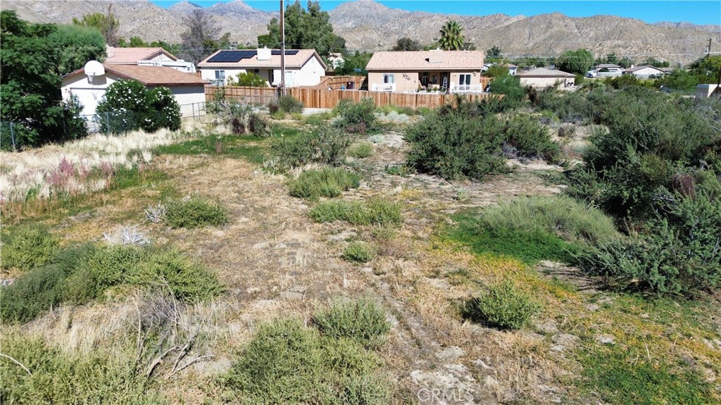 Welcome to an exceptional property opportunity in Morongo Valley, CA! Situated just a short 30-minute drive from both Joshua Tree National Park and Palm Springs, this 10,500 square foot lot presents an ideal canvas for potential home construction. Zoned for multifamily use, this parcel offers a unique chance to build a duplex, providing versatile living options. Alternatively, explore the exciting prospect of creating a vacation rental on this prime piece of real estate. Morongo Valley has a stunning night sky, creating an enchanting backdrop for stargazing enthusiasts. Don't miss out on the chance to turn this property into your dream home or a lucrative investment. Not a real address. Used for marketing purposes only.