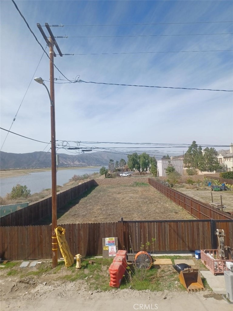 This prime lot sits on level terrain, making it an ideal canvas for your dream home. With breathtaking views of the lake and surrounding mountains, it offers a serene and picturesque setting perfect for those who love the outdoors. Whether you`re envisioning summers spent by the water or weekends out on your boat, this location is a haven for lake lovers, conveniently situated in a central area, you`re just minutes from shopping centers, grocery stores and everyday essentials. Plus, with easy access to the 15 freeway, commuting is breeze. Don`t miss the chance to build your perfect retreat in this unbeatable location! Has its own wooden fence and its door is sliding.