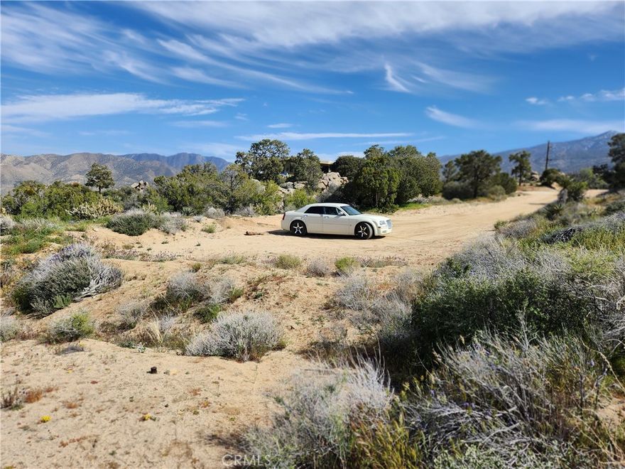 Beautiful 2.5 acre parcel with everything you're looking for privacy, tranquility, space, and views in this upscale community of Pinyon Crest! Incredible opportunity to develop a stunning 2001 sqft single story custom home. 3 bedrooms, 2 bathrooms with an attached 2 car garage at end of the road. Water provided by Homeowners Association. Enjoy the spectacular views, gorgeous terrain, trees, outcroppings, and native flora and fauna from your home. Have blueprints from a well known designer architect, approvals, and perc report. Initial permits for grading and septic, had been submitted. Parcel is approximately 20 minutes to Palm Desert and with a 4,000. ft elevation, the temperature enjoyed here ranges from 15 to 20 degrees cooler than from desert. Sparkling starlit nights, fresh air, and amazing panoramic views of Santa Rosa Mountain, scenic mountains, and Coachella Valley City lights, will make this a dream come true estate!