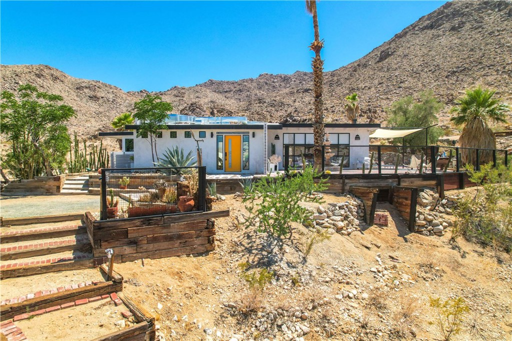 ***MOTIVATED SELLER***THE ONLY HOUSE FOR SALE WITH JOSHUA TREE NATIONAL PARK ON 2 SIDES!!!***
With the Joshua Tree National Park boundary on both the south and the west side of the property, thousands of acres of amazing open space land make a truly unique setting. Perched high on the mountain, this home looks over the surrounding areas as far as the eye can see. This very private getaway includes a main house with 2 bedrooms, 1 bathroom and a pool, a guest house studio with a bathroom, plus several outdoor patios and gardens to sit, dine and relax. Some of the new features include new, energy-efficient windows, energy-efficient mini-split heating and cooling, modernized kitchens and beautiful bathrooms. The house and guest house have been styled with modern-eclectic furnishings that add to the unique character and charm of this very special retreat. Seller will carry financing at a below market-level interest rate.
SELLER WILL CARRY FINANCING AT A BELOW MARKET-LEVEL INTEREST RATE