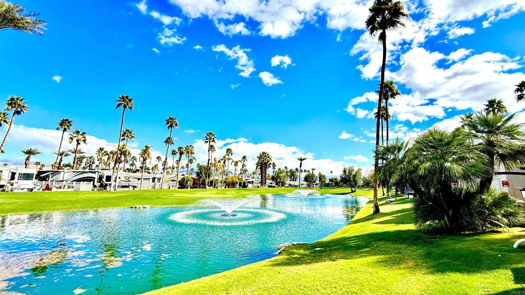 Lot 966, An ORPS trophy lot, this unique golf lot sits right on a back 9 water feature. With oversized paved pad, all green lush grass and flowers on your patio side, dramatic Mountain View, it’s a forever space. At the south end of the resort, you’re steps from the El Saguaro clubhouse. Enjoy all day desert sun! Outdoor Resort Palm Springs (ORPS) is a Guard Gated 5-Star RV Resort Community offering an active and luxurious lifestyle featuring golf (27 holes), tennis, pickleball, swimming and more! Two clubhouses, fitness center, beauty solan, La Roma Restaurant on campus, dog park and more!