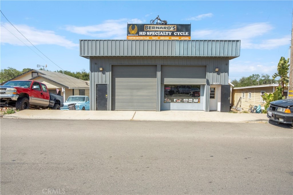 Wonderful opportunity to have a true live/work situation. This rare property is zoned commercial services and offers multiple uses. Presently, it is a motorcycle parts and repair facility. Store area in the front, repair facility around the back with alley access. Each area has a 1/2 bath. Upstairs, enjoy a recently remodeled 1 bedroom apartment with large living room and 2 bathrooms. Just added a brand new 50k solar system, completely paid for, which covers the entire building. Don't miss this chance to have a shop and living area all in one.